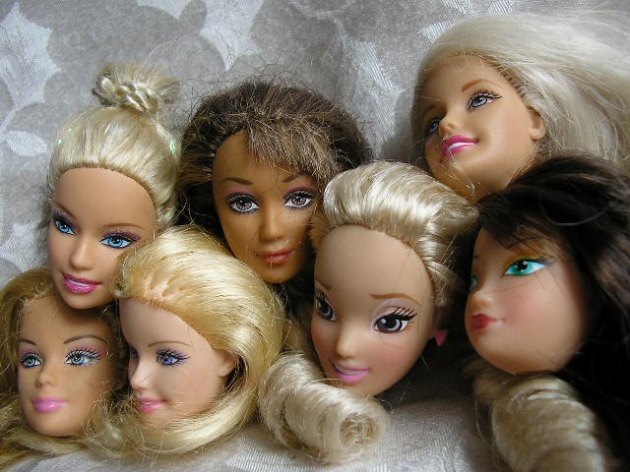 "Set of 7 Barbie and same size doll heads"...I do not like the way that one in the middle is looking at us...